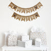 This burlap fishtail flag banner is hung in two lines. The top line starts with a flag with the words The stenciled in script lettering followed by a flag with a hand stenciled brown deer head silhouette. The end of the banner has another hand stenciled deer head followed by the word Is stenciled in script font on one flag. The full first line reads &quot;The Hunt Is&quot; The second line begins with another deer image followed by the word &quot;Over&quot; and then another deer stencil.