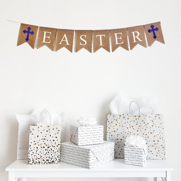 Easter burlap banner featuring purple cross flags on each end. The banner spells out the word Easter in white letters.