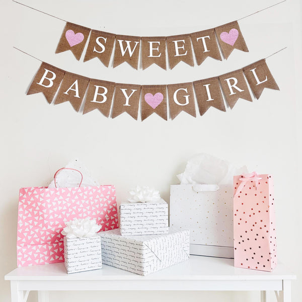 A Sweet Baby Girl burlap banner strung on one string. Hand painted pink hearts on each end of the word SWEET on the top layer, and then between the words BABY and GIRL on the second line.