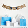 An It’s a Boy burlap banner strung on one string. Hand painted blue hearts are between the word it’s and a, and then between the words a and boy.