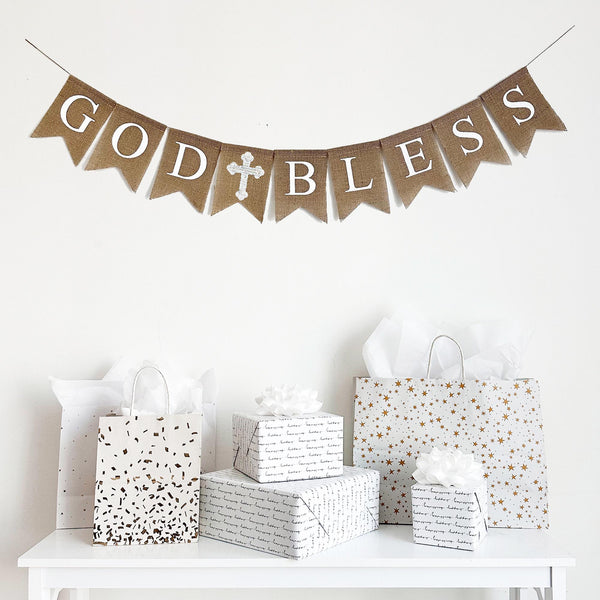 This burlap banner spells out the words God Bless with a white cross in between the two words. This banner is also available with a pink cross or a blue cross, making it the perfect addition to any color scheme or party theme.
