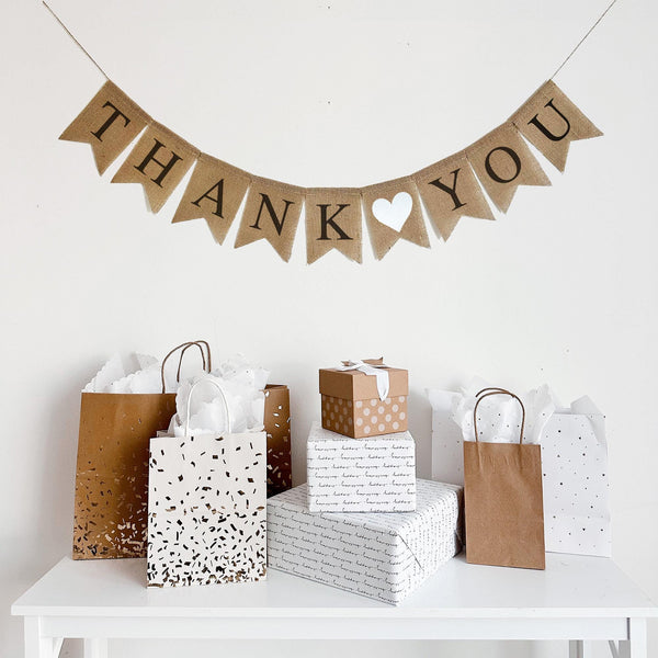 This rustic Thank You banner is written out in black lettering with a white heart between the two words. Perfect way to show your gratitude at a wedding, graduation party, or any other celebration.