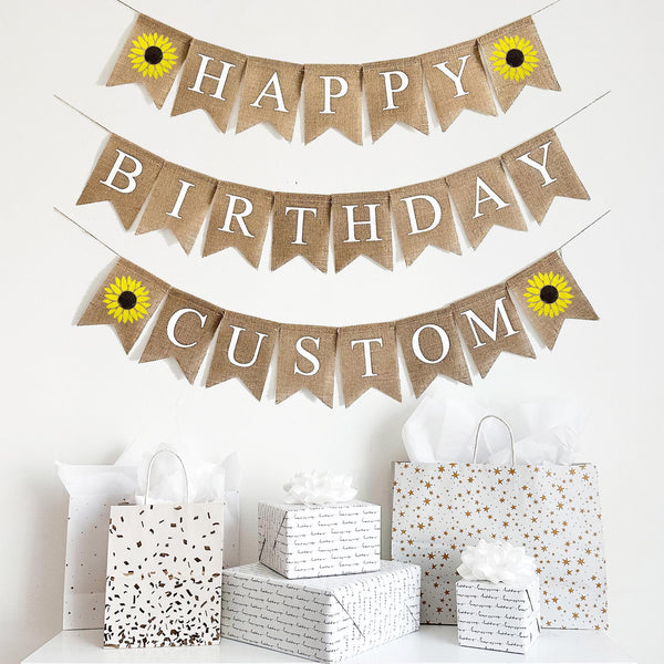 Sunflower themed Happy Birthday burlap banner with white letters and two vibrant yellow hand stenciled sunflowers. Add your custom wording on the third layer to add a personal touch to your event.