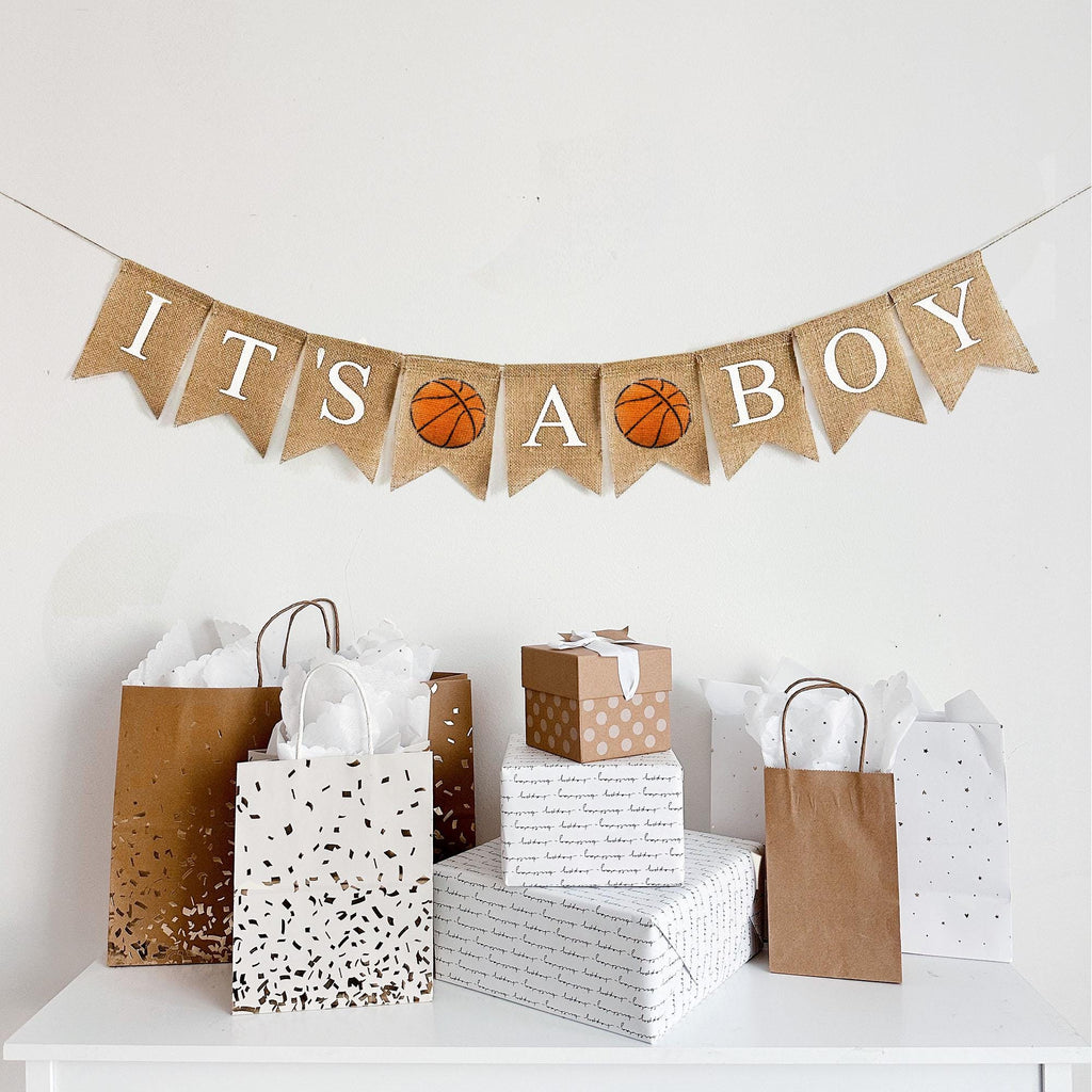 A burlap banner reading ITS A BOY with a basketball image flag between the words.
