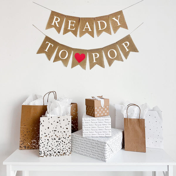 A burlap banner reading Ready To Pop with a red heart image  between the words.