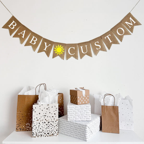 This burlap banner says BABY with a hand stenciled yellow sunshine followed by the wording of your choice! Add a custom name, date or saying to personalize your event.