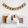 A burlap banner made from 4.5 by 6.5 inch fishtail shaped flags. Each flag has a pocket across the top for stringing. It says EIGH-TEE in black capital letters and has a hand stenciled image of a white golf ball sitting on a black tee on each end. It is strung on a jute string that is 110 inches in length.