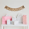 A burlap banner made from 4.5 by 6.5 inch fishtail shaped flags. Each flag has a pocket across the top for stringing. This is a custom banner in white capital letters with a hand stenciled image of a brown horse with a pink saddle on each end. Add a name or word of your choosing to customize the banner. It is strung on two 110 inch jute strings.