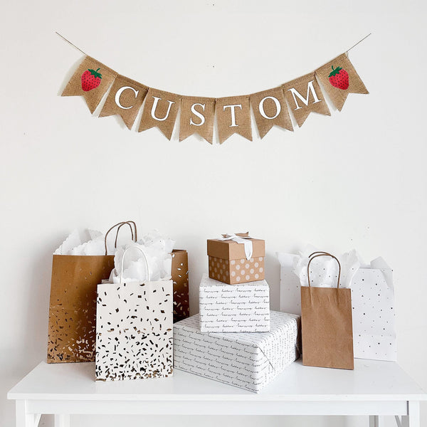 This strawberry themed banner is the perfect addition to any celebration. Personalize this banner to say a name, date or phrase to complement your celebration. This custom banner includes two hand stenciled red strawberries on either end of the wording of your choice.