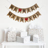 A burlap banner made from 4.5 by 6.5 inch fishtail shaped flags. Each flag has a pocket across the top for stringing. The top line of this banner says WE WILL in black capital letters with a red heart between the words. The bottom line says MISS YOU in black capital letters with a red heart between the words. It is strung on two 110 inch jute strings.