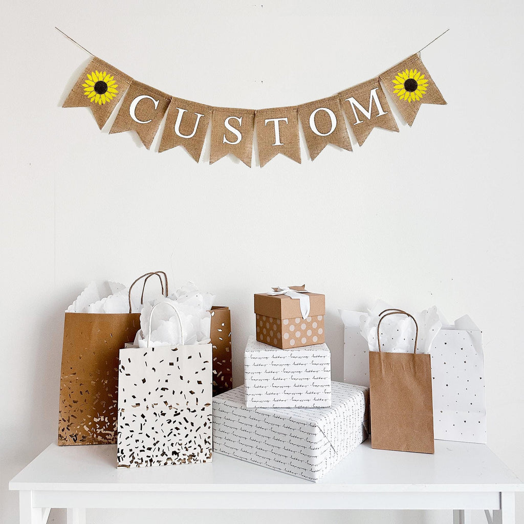 Customize this sunflower burlap banner with a word, date or saying to personalize your event. Each banner comes in black or white letters  and is accented by a hand stenciled yellow sunflower on each end of your wording of choice.