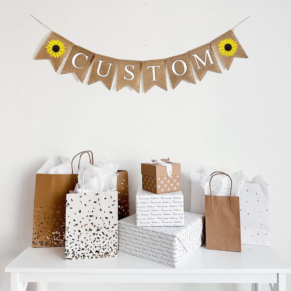 Customize this sunflower burlap banner with a word, date or saying to personalize your event. Each banner comes in black or white letters  and is accented by a hand stenciled yellow sunflower on each end of your wording of choice.