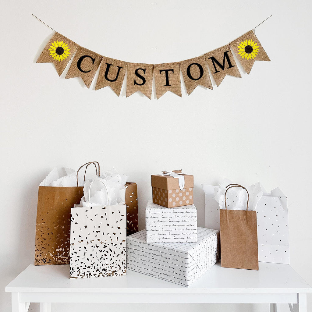 Customize this sunflower burlap banner with a word, date or saying to personalize your event. Each banner comes in black or white letters  and is accented by a hand stenciled yellow sunflower on each end of your wording of choice.