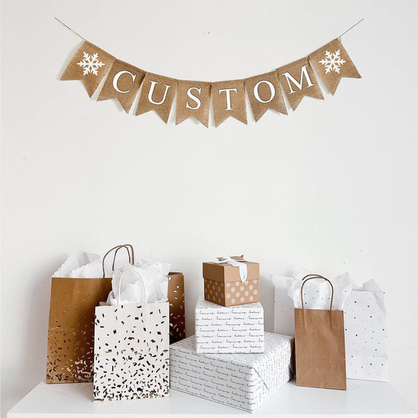 Each flag on this burlap banner measures 4.5 x 6.5 with white letters printed on each flag. This banner has two white glitter snowflakes surrounding the personalized wording of your choice.