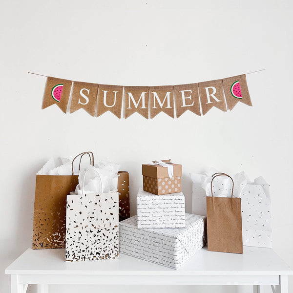 Summer Burlap Banner. Summer is written in white lettering on burlap flags with a hand stenciled pink & green watermelon on each end of the word.