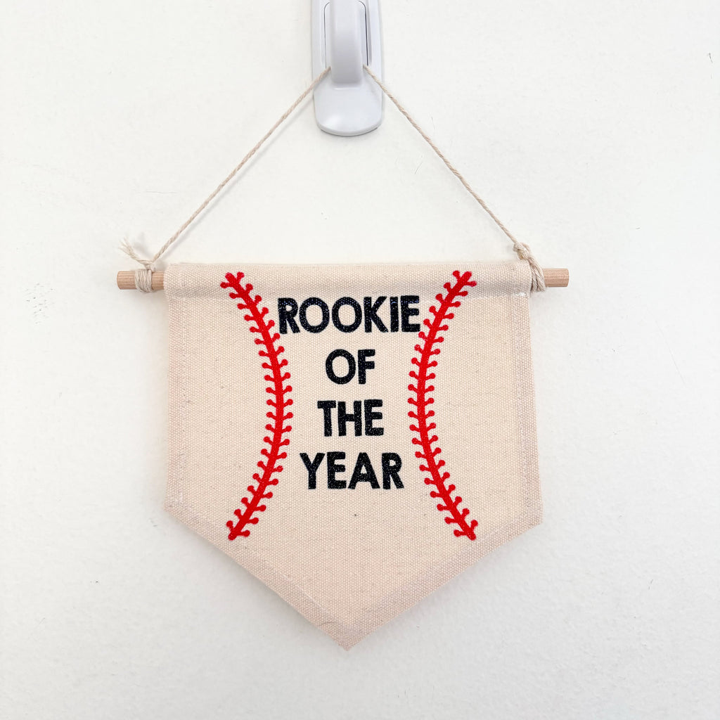 Rookie of the year banner on a wooden dowel hanging on a wall